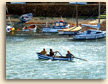 Three Boys in a Boat at Mousehole in Cornwall